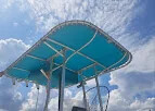 Turquoise canvas T-top on a stainless steel frame against a cloudy sky